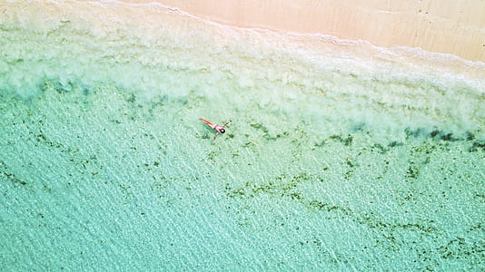 person lying on green water thumbnail