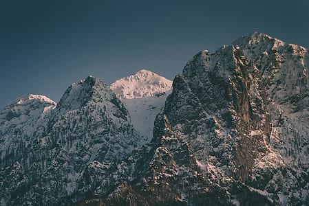 aerial photography of mountain peak under gray sky thumbnail