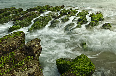body of water and stones photo at daytime thumbnail