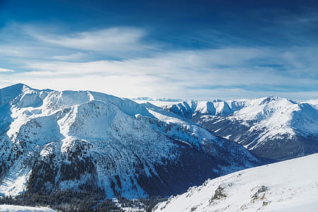aerial photo of mountain covered by white snow under white clouds during daytime thumbnail