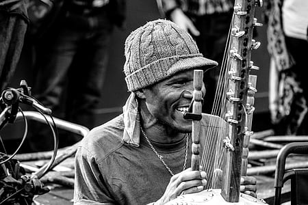 man holding flute and harp thumbnail