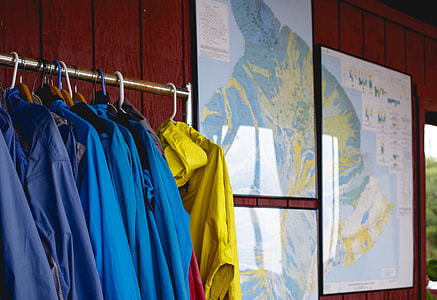 assorted clothes hanging on stand thumbnail