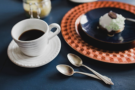 Sweet little white chocolate dessert on a blue saucer in a cake shop thumbnail