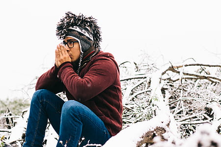 man sitting on snow covered mountain thumbnail