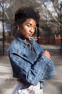 woman wearing blue denim jacket outside during daytime thumbnail