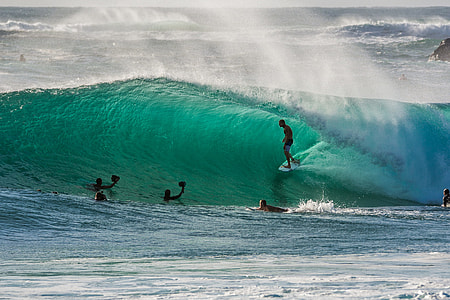 group of people surfing in the body of water thumbnail