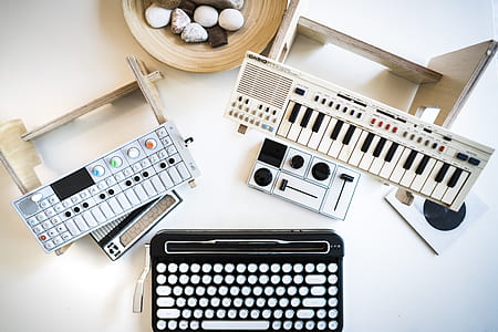white Casio electronic keyboard on white wooden surface thumbnail