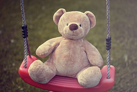 close-up photo of brown bear plush toy swinging thumbnail