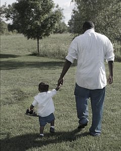 man and toddler walking wearing white long-sleeves shirts thumbnail