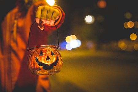 Little Girl Holding Halloween Candle Holder thumbnail