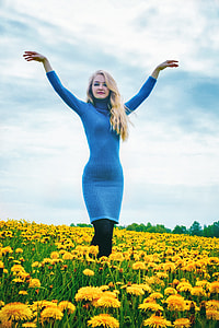 woman in blue turtleneck long-sleeved dress and black pants thumbnail