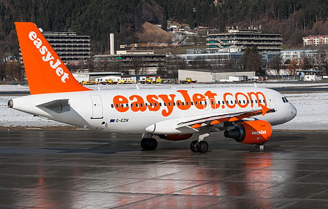 white and orange EasyJet plane during daytime thumbnail