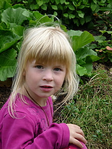 girl sitting near green leafed plant thumbnail