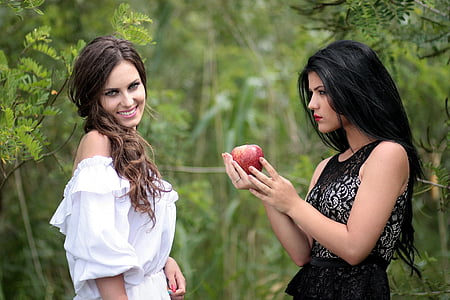 black haired woman wearing black sleeveless dress thumbnail
