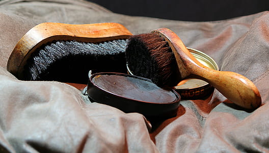 two brown handle shoe brushes on grey textile thumbnail