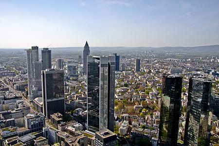 high-angle photography of concrete buildings under white and blue sky at daytime thumbnail