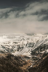 brown mountain covered by snow at daytime thumbnail