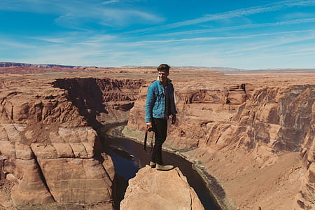 man standing on rock formation thumbnail