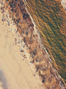 sea waves beside brown rocky cliff thumbnail