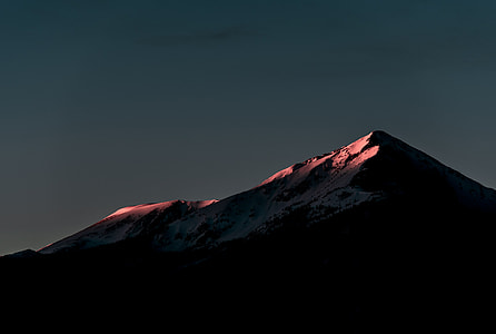 silhouette of rocky mountains under gray sky thumbnail