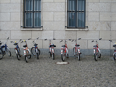 assorted city bicycles near white wall thumbnail