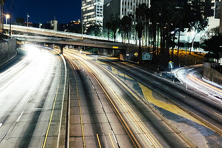 bridge near buildings during night time thumbnail