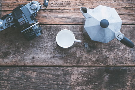 flat lay photography of cup, camera, and moka pot thumbnail