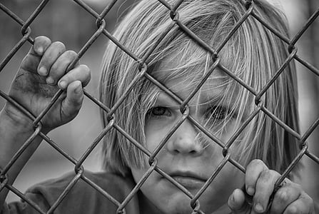 toddler in gray metal fence thumbnail