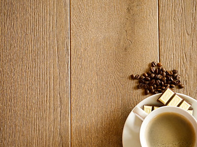 coffee on teacup and coaster on wood plank thumbnail