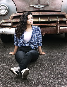 Woman Sitting on Gray Pavement Near Vintage Gray and Brown Car thumbnail