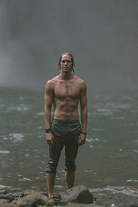 man standing on river thumbnail