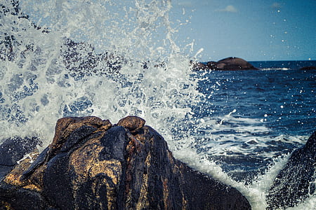 body of water splashing on rock thumbnail