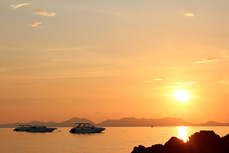 several white boats on water during sunset thumbnail