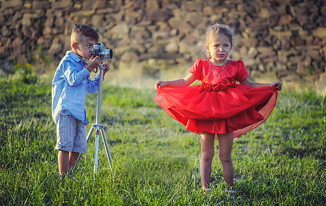 two children boy and girl on green grass field during daytime photo thumbnail