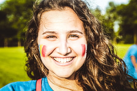woman smiling with paint on cheek thumbnail