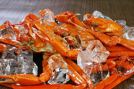 crabs and ice cubes on brown wooden surface thumbnail