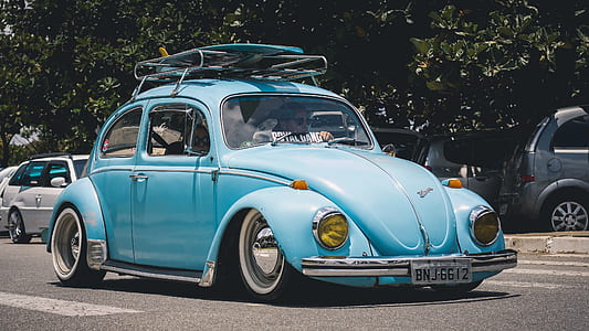 blue Volkswagen Beetle coupe on road at daytime thumbnail