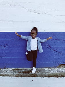 girl standing in front of blue and white wall thumbnail
