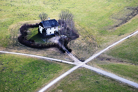 white and black house surround by bare trees thumbnail