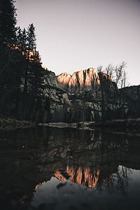 body of water across snow covered mountain thumbnail
