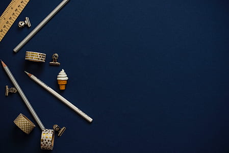 white pencil and silver-colored band ring thumbnail