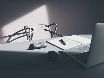 gray calculator near black cordless computer mouse and silver laptop computer thumbnail