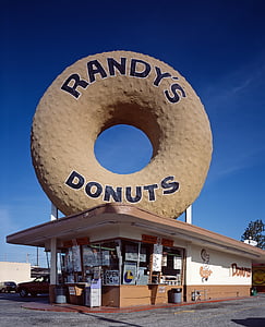 person taking photo of Randy's Donuts store at daytime thumbnail