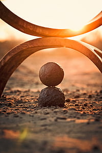 round stone and view of sunset thumbnail