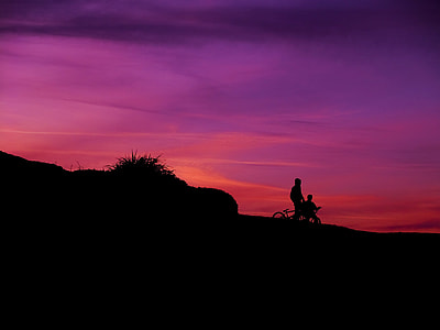 silhouette of two person riding bicycles thumbnail