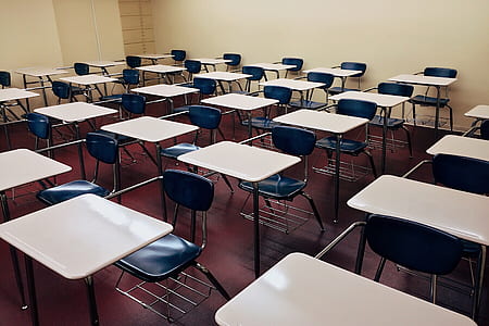 white tables and black chairs in room thumbnail
