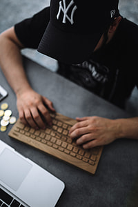 Young man typing on the wooden keyboard thumbnail
