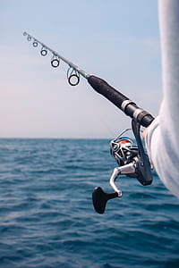 person holding fishing rod with spinning reel thumbnail