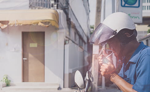 person wearing helmet about to light the cigarette thumbnail