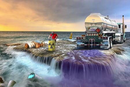 photo of gray trailer truck near person working on yellow hazard labeled barrel on above water surface thumbnail